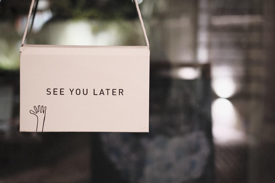 A sign attached to a door saying See You Later.